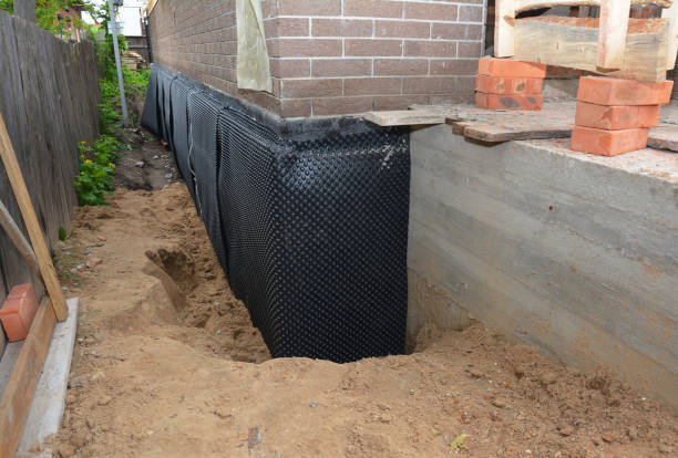 Happy homeowners after waterproofing job in Frederick